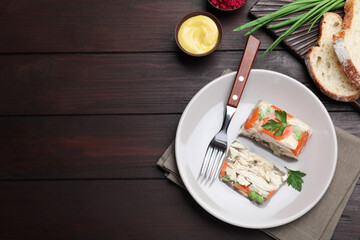 Fototapeta na wymiar Delicious chicken aspic served on wooden table, flat lay. Space for text