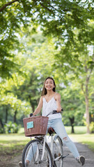 Fototapeta na wymiar Happy woman legs up riding bike in spring park