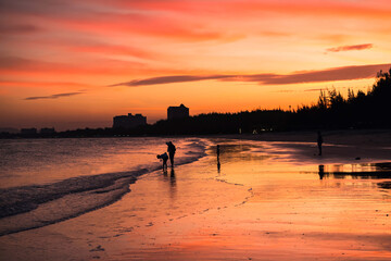 Happy silhouette family enjoy beach at dusk