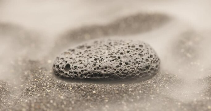 Smoke whirling around small meteorite stone