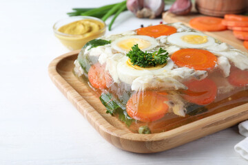 Delicious fish aspic served on white wooden table, closeup