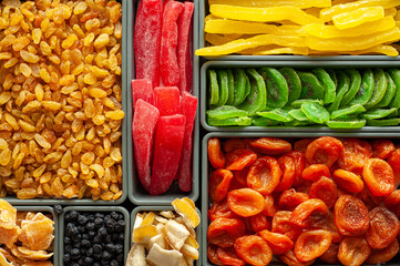 A set of dried fruits and candied fruit. The counter is on the market with dried fruits. Winter healthy sweets. Winter vitamins. Vegan sweets. Food background.