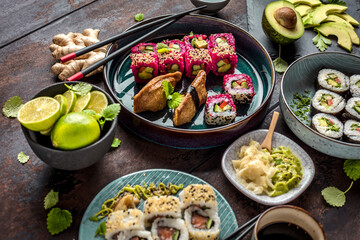 japanese sushi food. Maki ands rolls with tuna, salmon, shrimp, crab and avocado. Top view of assorted sushi. Rainbow sushi roll, uramaki, hosomaki and nigiri.