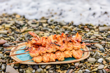 langoustine tails on skewers cooked on charcoal