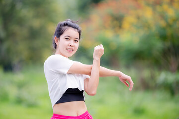 A beautiful Asian woman is warm up, To make the muscles flexible Before going to jogging