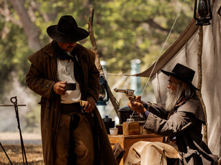 Twin senior cowboys are resting while protecting the safety of the camp in the western area