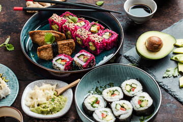 japanese sushi food. Maki ands rolls with tuna, salmon, shrimp, crab and avocado. Top view of assorted sushi. Rainbow sushi roll, uramaki, hosomaki and nigiri.