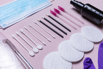 Anti virus hygienic makeup covid with disposable material, alcohol and mask. Pink background. Top...