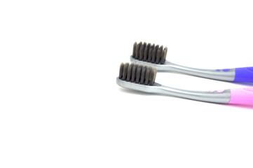 Children's toothbrushes, with toothpaste and reflection in the mirror.