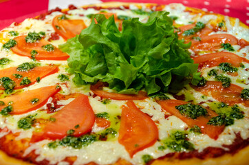 Pizza with tomatoes, cheese and herbs