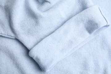 Fototapeta premium Warm cashmere sweater as background, top view