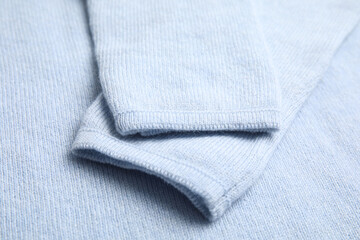 Warm cashmere sweater as background, closeup view