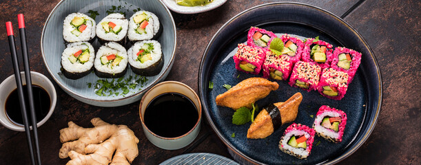 japanese sushi food. Maki ands rolls with tuna, salmon, shrimp, crab and avocado. Top view of assorted sushi. Rainbow sushi roll, uramaki, hosomaki and nigiri.