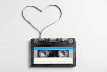 Music cassette and heart made with tape on white background, top view. Listening love song
