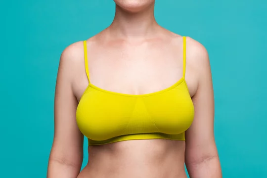 Happy Woman in Yellow Top Bra with Big Natural Breasts on Blue Background  Stock Image - Image of happiness, healthy: 193752751