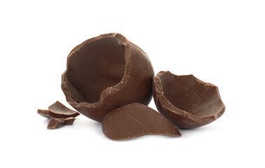 Broken milk chocolate egg on white background