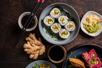 japanese sushi food. Maki ands rolls with tuna, salmon, shrimp, crab and avocado. Top view of assorted sushi. Rainbow sushi roll, uramaki, hosomaki and nigiri.