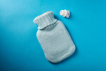 Rubber heating pad on blue background, top view