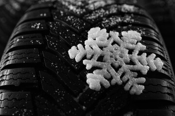 Snowy new winter tires as background, closeup