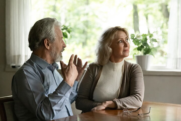 Offended mature woman ignoring angry man, upset aged wife not talking with husband, elderly couple arguing, family conflict and quarrel concept, misunderstanding in relationship, bad marriage