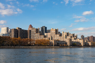Fototapeta na wymiar Roosevelt Island Skyline along the East River in New York City during Autumn with Colorful Trees