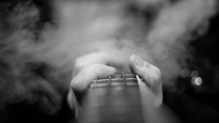 close up of a person playing guitar