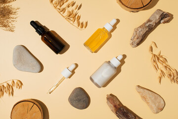 Fototapeta na wymiar Natural cosmetic concept with serum and cream tube and bottles with natural materials