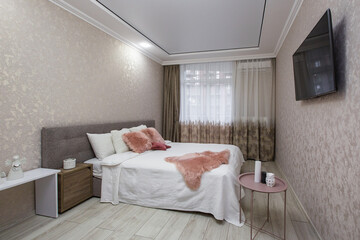 Fototapeta na wymiar Interior photography, large bedroom with large bed, and TV in a modern style