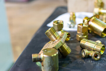 Brass and bronze grommets and threaded adapters are in bulk in the warehouse.