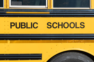 Public schools block lettering on the side of a school bus