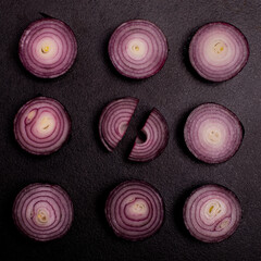 Red onion patter on blackbackground with sun light, flat lay concept vegetable.