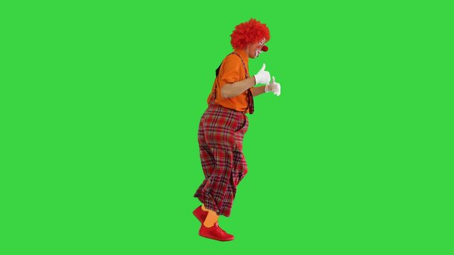 Happy clown show thumbs up while walking on a Green Screen, Chroma Key.