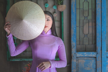 Young Vietnam woman wearing Ao Dai culture traditional at old temple at Ho Chi Minh in Vietnam,vintage style,travel and relaxing concept. - 408098670