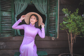 Young Vietnam woman wearing Ao Dai culture traditional at old temple at Ho Chi Minh in Vietnam,vintage style,travel and relaxing concept. - 408098684
