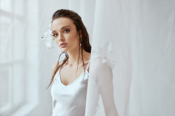 Portrait of girl with lily flower behind ear.