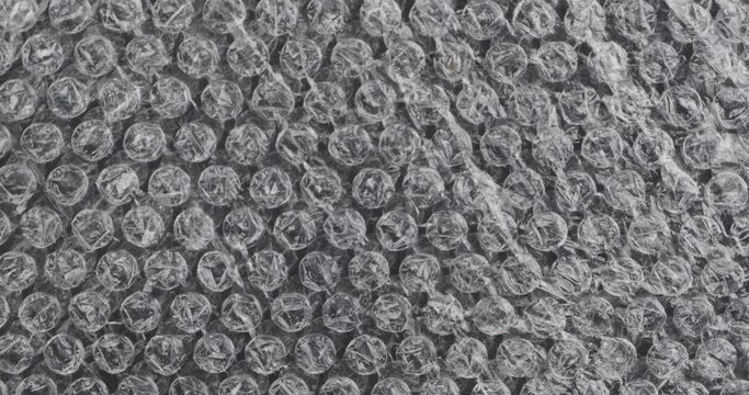 Rotating bubble wrap to protect the product. Bubble wrap, background and texture.