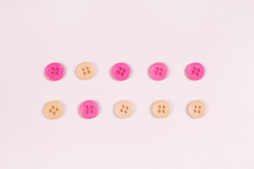 lilac and beige buttons are folded in two parallel lines; the second ones in the line are swapped