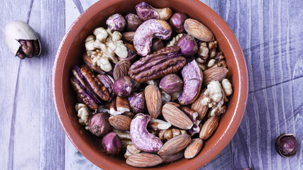 variety of nuts almonds hazelnuts cashews walnuts on a wooden background top view place under the text	