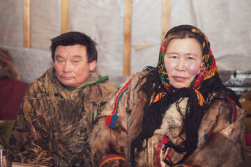 Husband and wife in the national winter clothes of the northern inhabitants of the tundra, the Arctic circle