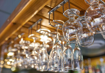 glasses for wine above a bar rack