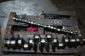 Photo of a crankshaft from a disassembled engine from an auto engine with pistons at a service station