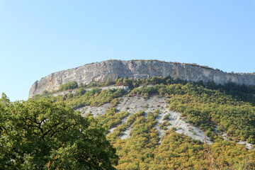 autumn in the mountains limestone cliff surrounded by colorful forest