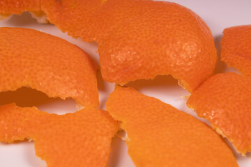 peel from a tangerine scattered chaotically, orange side up