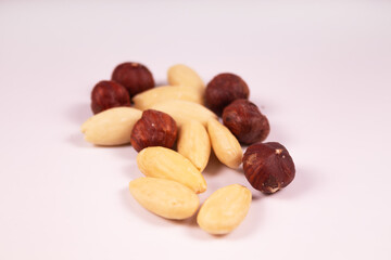 peeled almonds mixed with hazelnuts in the center of the frame