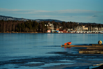Fototapeta premium Outdoors at Kalvøya, Sandvika, Bærum, Norway. Ice cold winter day, but the sun is shining and is heating a little bit. 