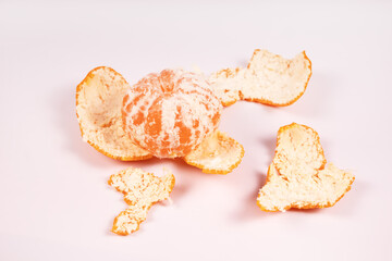 the peel from the tangerine lies around the tangerine itself and under it