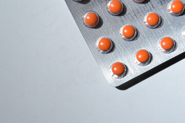 Medicine pills are packed in blisters, lie on a light background. close-up.