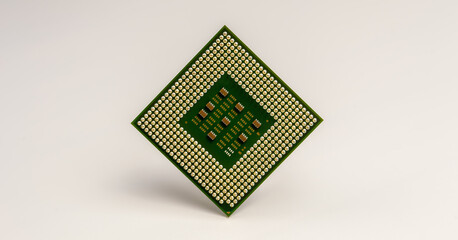 close-up of computer central processor unit with golden pins on white background