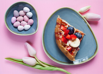 Fresh Belgian Waffle with starwberry, banana, blueberry and fruit syrup and Easter eggs.