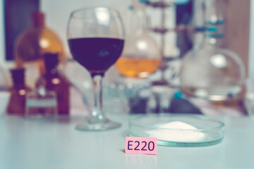 Wine laboratory. Wine test for sulfur dioxide content. Colored plate with the name e-additives and...